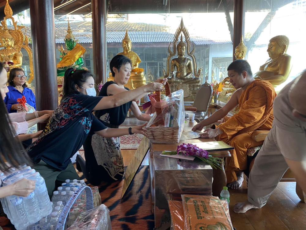 Donation at a Buddhist temple.