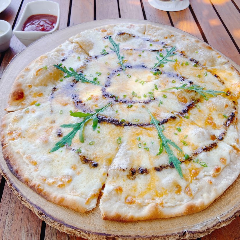 Four Cheese Pizza. Truffle oil and honey works as accent (Paresa meal)